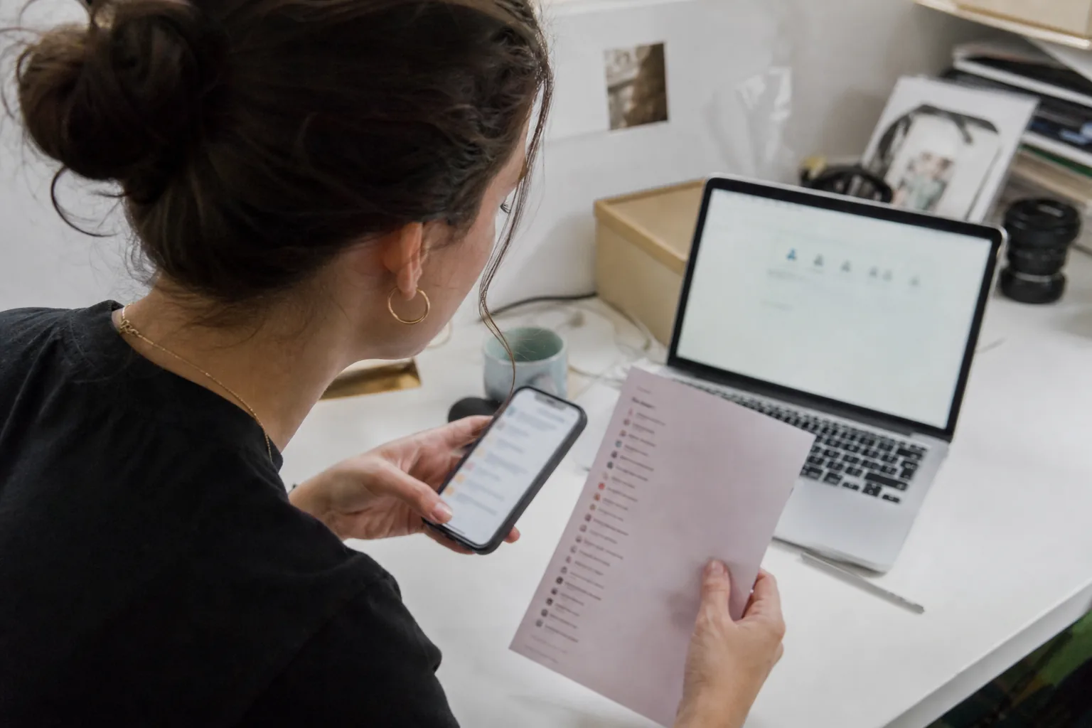 Social media manager reviewing a list of brand handles at a desk