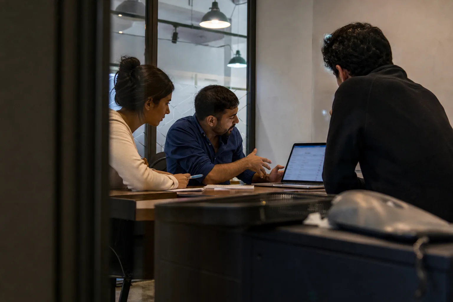 Risk operations team discussing account reviews in a meeting room